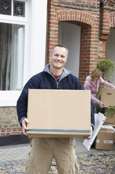 Moving team loading boxes safely into a van