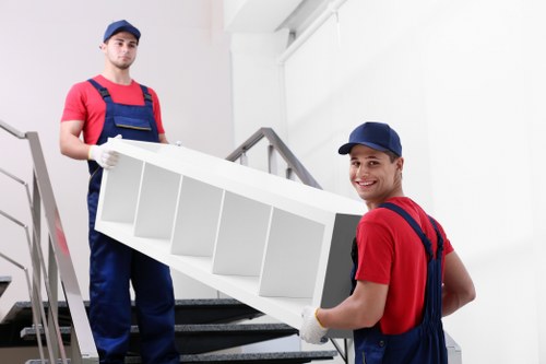 Packed boxes and furniture ready for same day removals in a North London flat