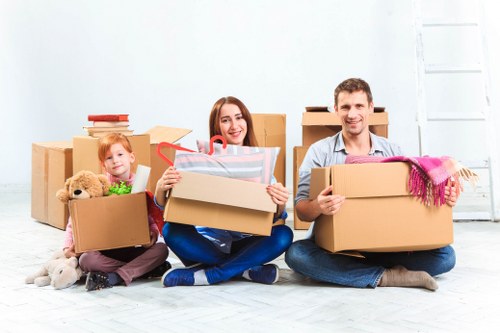 Careful loading of a sofa and boxes into a moving van