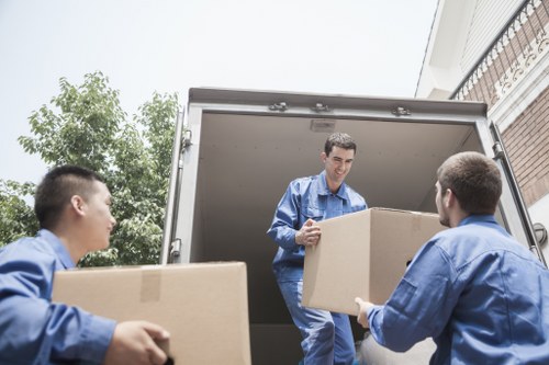 Furniture being carried through a narrow stairwell in a flat move
